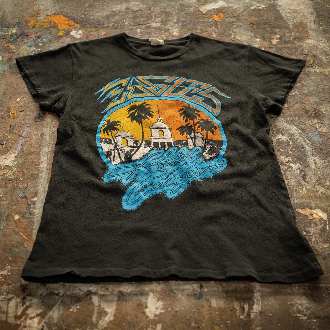 tee-black-sunset with hotel california building and palm trees eagles logo